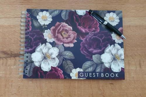 a notebook with a guest book and a pen at Beaumont at 2 Le Roux in Robertson