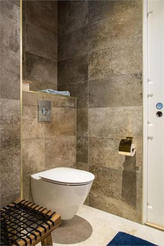 a bathroom with a toilet and a glass shower at Beautiful and cosy house near the lake in Olofström