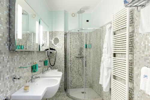 a bathroom with a sink and a shower and a sink at Hotel Palazzo Papaleo in Otranto