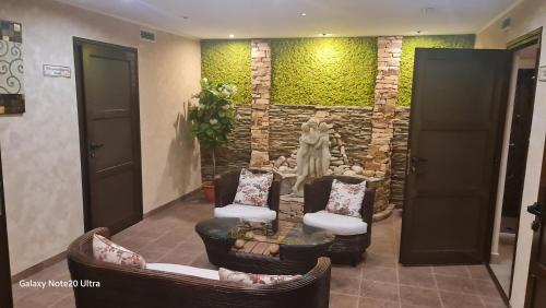 a lobby with two chairs and a statue in a room at Suite Roma 2 at Spa Club Bor in Velingrad