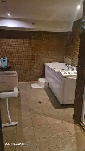 a bathroom with a tub and a sink at Suite Roma 2 at Spa Club Bor in Velingrad