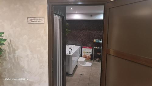 an open door to a bathroom with a toilet at Suite Roma 2 at Spa Club Bor in Velingrad
