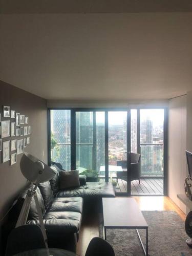 a living room with a couch and a table at Luxury apartment stunning views in Manchester