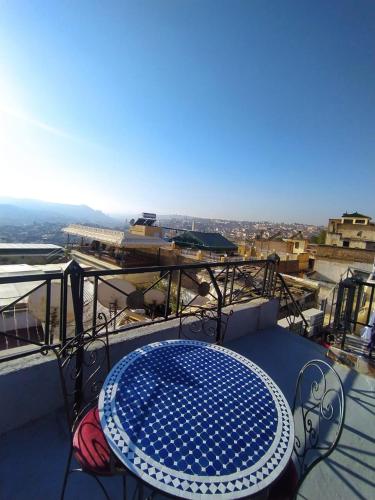 a table and chairs on a balcony with a view at Dar Atlantic in Fès
