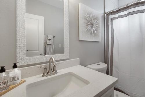 a white bathroom with a sink and a toilet at DESERT JEWEL in Tucson