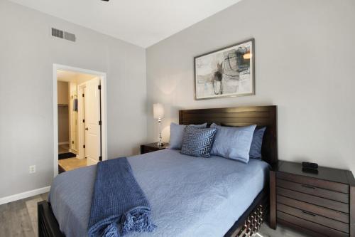 a bedroom with a large bed with a blue blanket at DESERT JEWEL in Tucson
