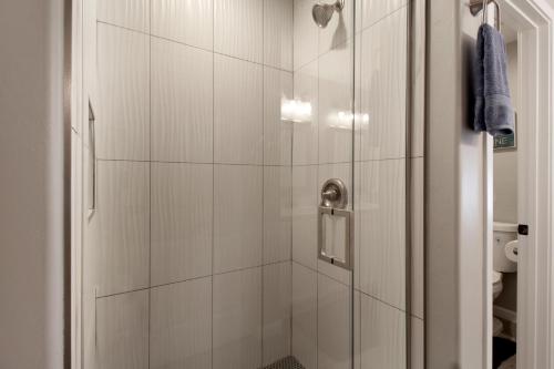 a bathroom with a shower with a glass door at DESERT JEWEL in Tucson