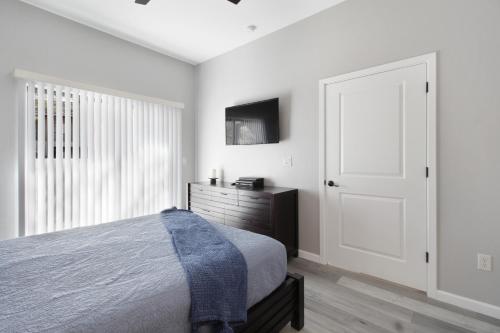 a bedroom with a bed and a dresser and a window at DESERT JEWEL in Tucson