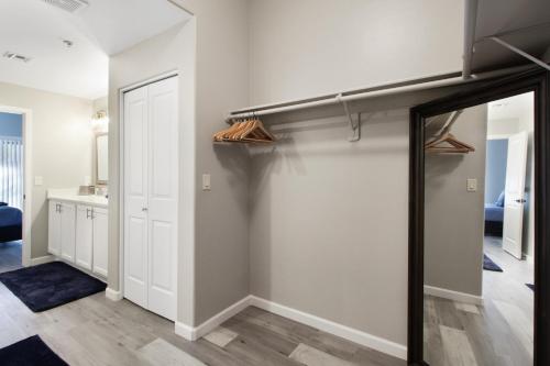 a walk in closet with white walls and a mirror at DESERT JEWEL in Tucson