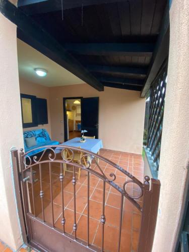 a balcony of a house with a bed in a room at Bilocale al Villaggio degli ulivi SAN TEODORO in San Teodoro