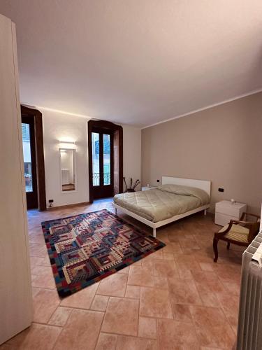 a bedroom with a bed and a rug on the floor at La casa del corso in Arona