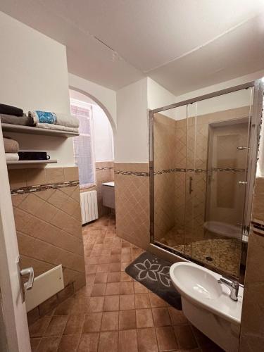 a bathroom with a shower and a sink at La casa del corso in Arona