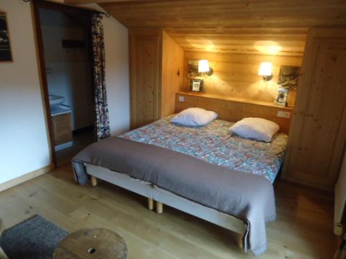 ラ・クリュサにあるAppartement La Clusaz, 3 pièces, 8 personnes - FR-1-459-18の木製の部屋にベッド1台が備わるベッドルーム1室があります。