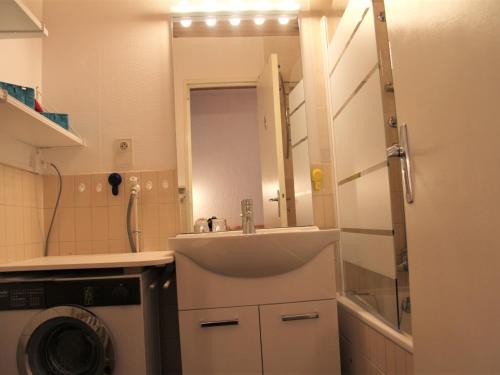 a small bathroom with a sink and a washing machine at Appartement La Clusaz, 2 pièces, 6 personnes - FR-1-459-83 in La Clusaz