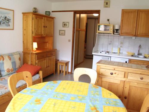 a kitchen with a table and chairs and a dining room at Appartement La Clusaz, 2 pièces, 4 personnes - FR-1-459-92 in La Clusaz