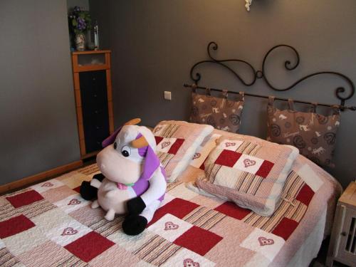 a stuffed animal sitting on top of a bed at Appartement La Clusaz, 2 pièces, 4 personnes - FR-1-459-110 in La Clusaz