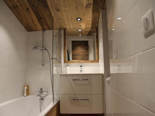 a bathroom with a shower and a sink and a tub at Appartement La Clusaz, 3 pièces, 6 personnes - FR-1-459-136 in La Clusaz