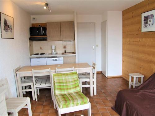 une cuisine et une salle à manger avec une table et des chaises dans l'établissement Charmant appartement 2 pièces + 2 coins nuit avec balcon au centre de La Clusaz, pour 4-6 personnes - FR-1-459-175, à La Clusaz