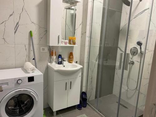 a bathroom with a washing machine and a shower at Ulcinj Apartments in Ulcinj