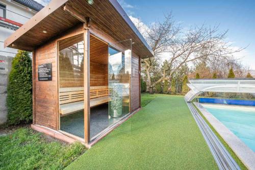 a house with a swimming pool next to a yard at Panorama Buda in Budapest