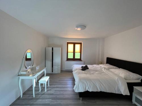 a bedroom with a bed and a desk and a mirror at Apartment Golden Prague 78 in Vestec