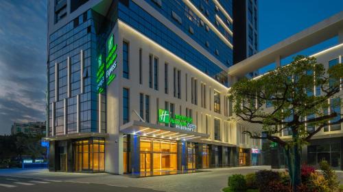 a building with a lit up sign on it at Holiday Inn Express Shunde Daliang by IHG in Shunde