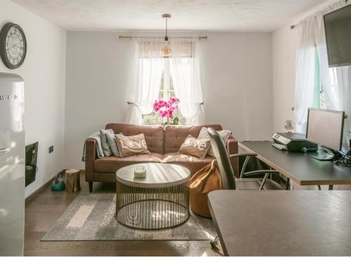 uma sala de estar com um sofá e uma mesa em Papworth apartment em Papworth Everard