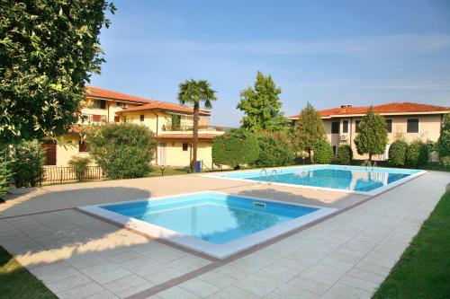 a swimming pool in front of a house at Residence Primavera in Bardolino