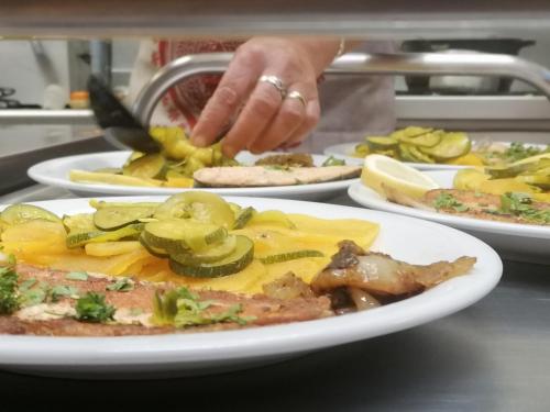 a person is reaching for a plate of food at Chambres d'hôtes L'Astazou in Gavarnie