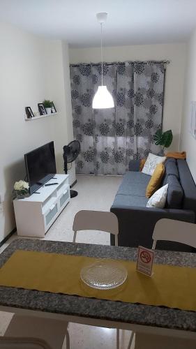 a living room with a bed and a couch at Rosyshome102 in Vecindario