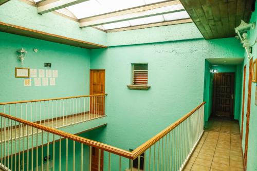 an empty hallway of a building with a blue wall at Hotel Juarez in Mexico City