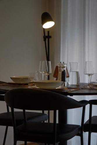 a dining room table with plates and glasses on it at Schönes Neubau Serviced-Apartment mit Parkplatz in Bruchsal