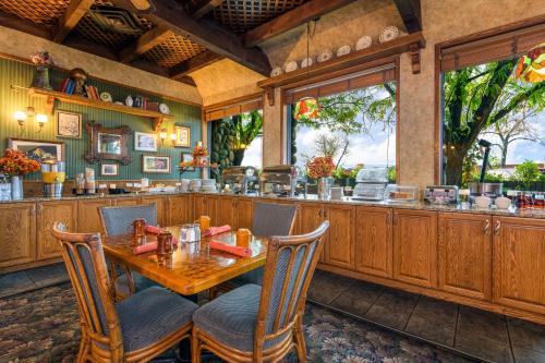 a dining room with a table and a bar at Grand Vista Hotel Grand Junction in Grand Junction