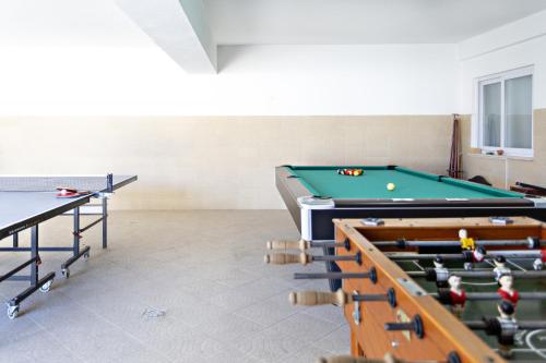 a room with pool tables and ping pong balls at Suite Bela Vista in Tavira