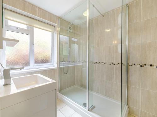 a bathroom with a glass shower and a sink at Cornish Riviera - Mount Brioni in Downderry