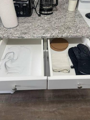 a kitchen counter with white drawers under a counter at Wonderful 2-bedroom apartment in Camrose
