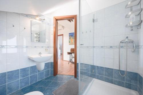 a bathroom with a shower and a sink and a toilet at Panorama Buda in Budapest