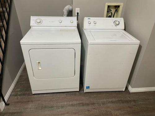 two white appliances sitting next to each other in a room at Wonderful 2-bedroom apartment in Camrose