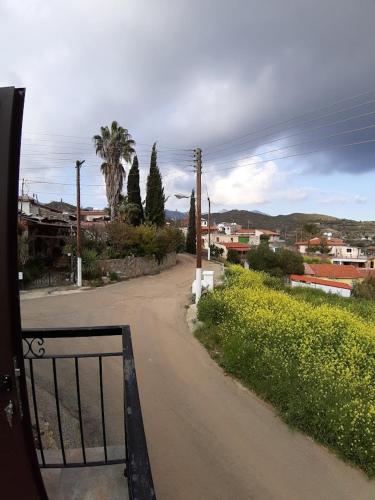 a road with a gate on the side of a street at THE ROCK HOUSE - Beautiful countryside with mandarins oranges and olive trees,. Near Limassol at Eptagonia village. in Ephtagonia