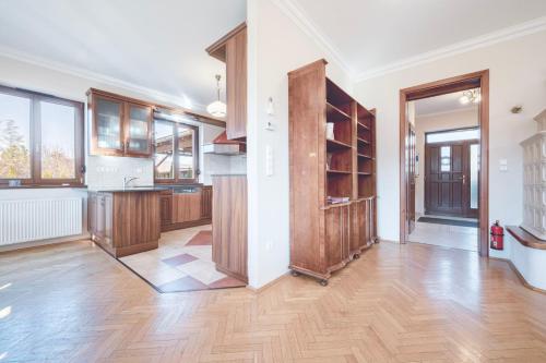 een grote keuken met houten kasten en een harde houten vloer bij Panorama Buda in Boedapest