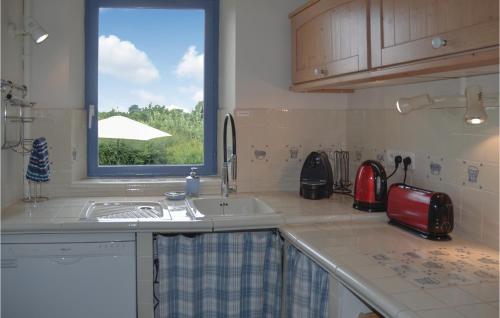 a kitchen with a sink and a window at Beautiful Home In Bouére in Saint-Brice