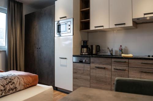 a kitchen with a white refrigerator and a microwave at Luxapart Haus 2 in Ladis