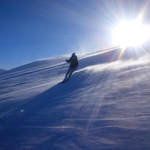 a person is skiing down a snow covered slope at Apartmány Horalka in Liptovský Mikuláš