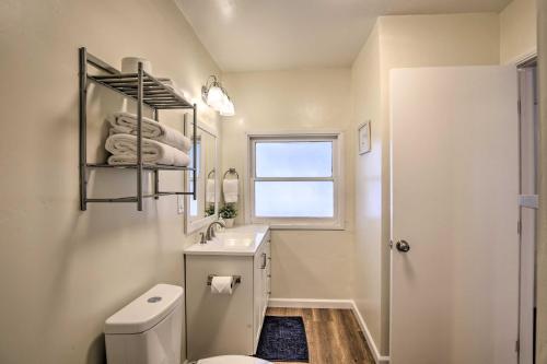 a bathroom with a toilet and a sink and a window at Updated Chula Vista Townhome - WFH Friendly! in Chula Vista