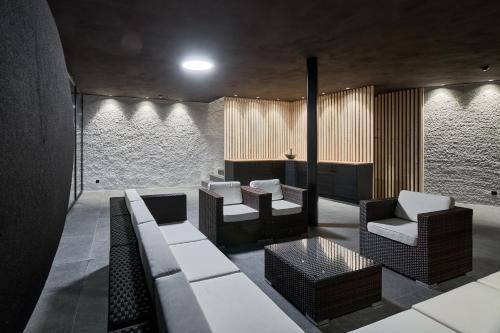 a living room with a couch and chairs at Wellness-Sporthotel Ratschings in Racines