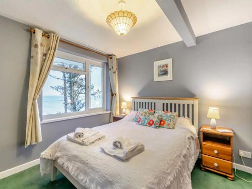 a bedroom with a bed with towels on it at Sand Bar - Mount Brioni in Downderry