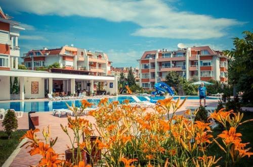 a resort with a swimming pool and some buildings at Sunny Fort Apartments in Sunny Beach