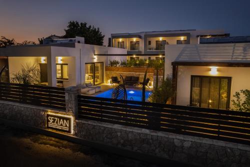 a house with a swimming pool at night at Sezian Boutique Homes and Villas in Preveza