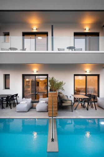 a house with a swimming pool in front of a house at Sezian Boutique Homes and Villas in Preveza
