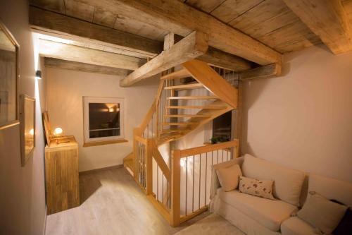 a living room with a staircase and a couch at La grange de Sophie in Berstett